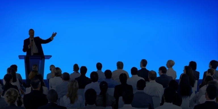 corporate-businessman-giving-business-presentation-large-audience
