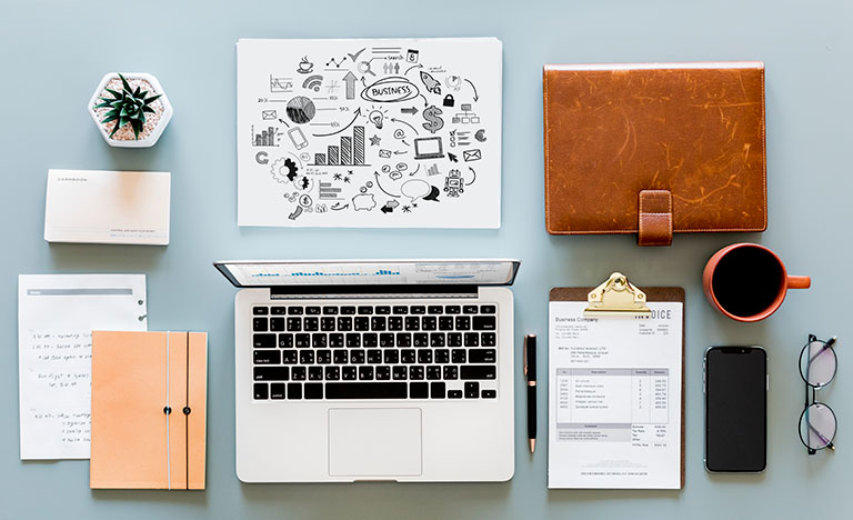 business marketing materials on desk laptop documents and stationery