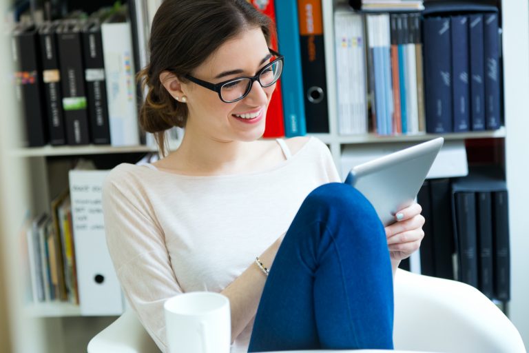 Think about your readers woman reading a magazine on a tablet