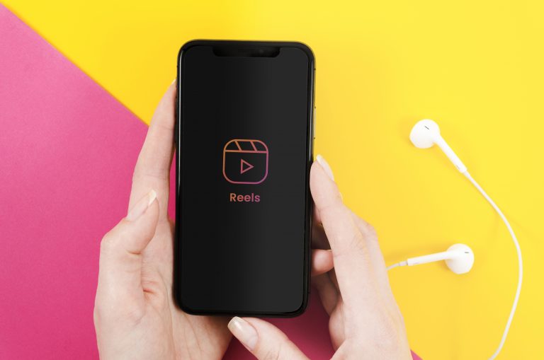 Holding smartphone watching reels