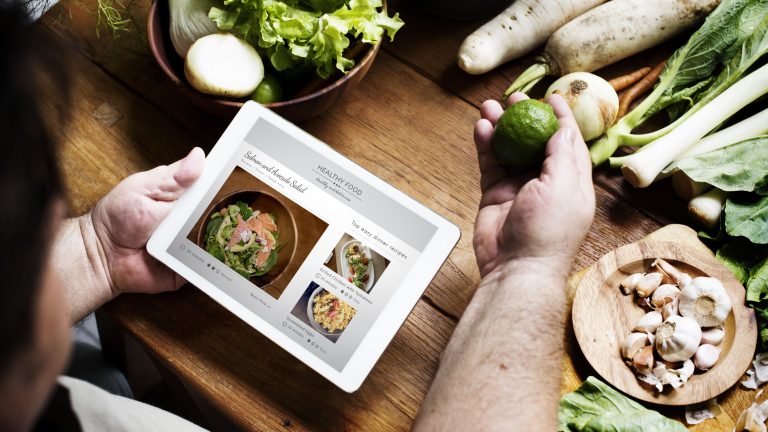 Man reading the cookbook online