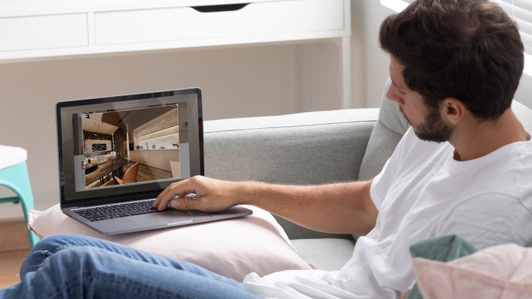 Man watching a virtual tour in a flipbook on a laptop