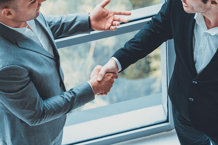 business handshake on a sponsorship proposal