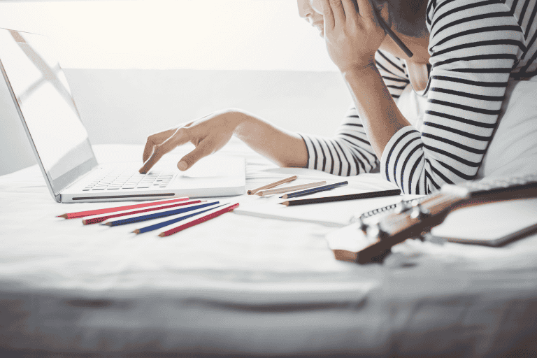 woman designing a marketing brochure on a laptop